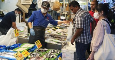 Shoppers examine seafood at a fish store in Tokyo, Japan, Sept. 25, 2023. China imposed a ban on the import of Japanese seafood on Aug. 24, 2023, just after Japan started releasing treated water from Tokyo Electric Power Company's tsunami-crippled Fukushima Daiichi nuclear power plant. (EPA Photo)