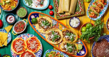 Mexican festive food for independence day independencia – chiles en nogada, tacos al pastor, chalupas pozole, tamales, chicken with mole poblano sauce. (Getty Images Photo)