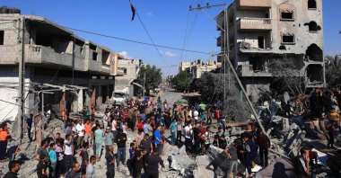 Palestinians gather at the site of collapsed and damaged buildings following an Israeli airstrike in Rafah, in the southern Gaza Strip, Palestine, Oct. 16, 2023. (AFP Photo)