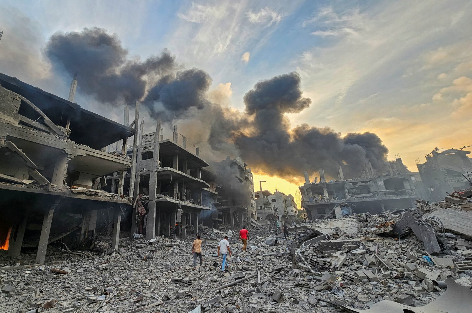 Palestinians walk past houses and buildings destroyed in Israeli strikes, in Jabalia in the northern Gaza Strip, Oct. 11, 2023. (Reuters Photo)