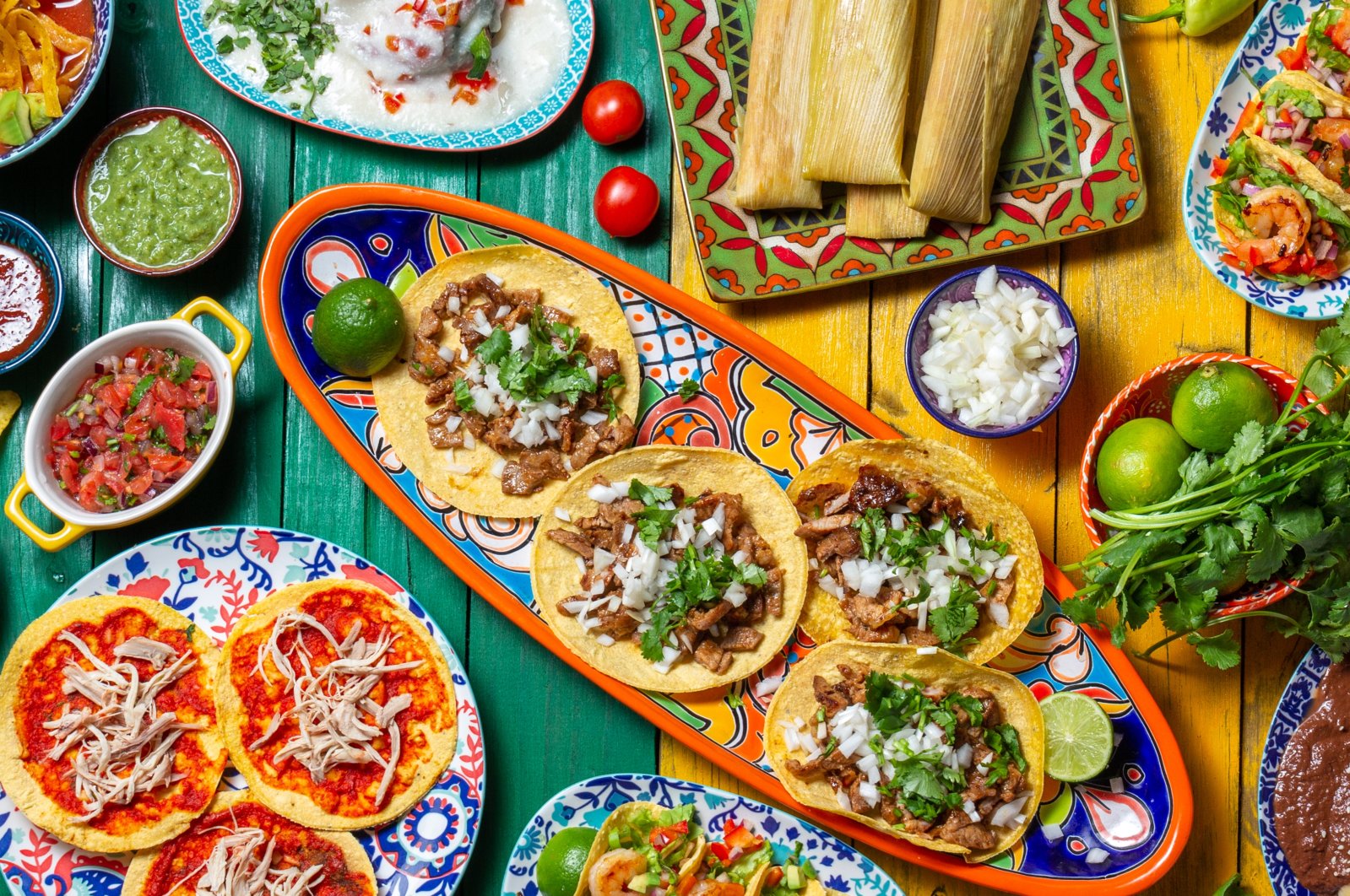 Mexican festive food for independence day independencia – chiles en nogada, tacos al pastor, chalupas pozole, tamales, chicken with mole poblano sauce. (Getty Images Photo)