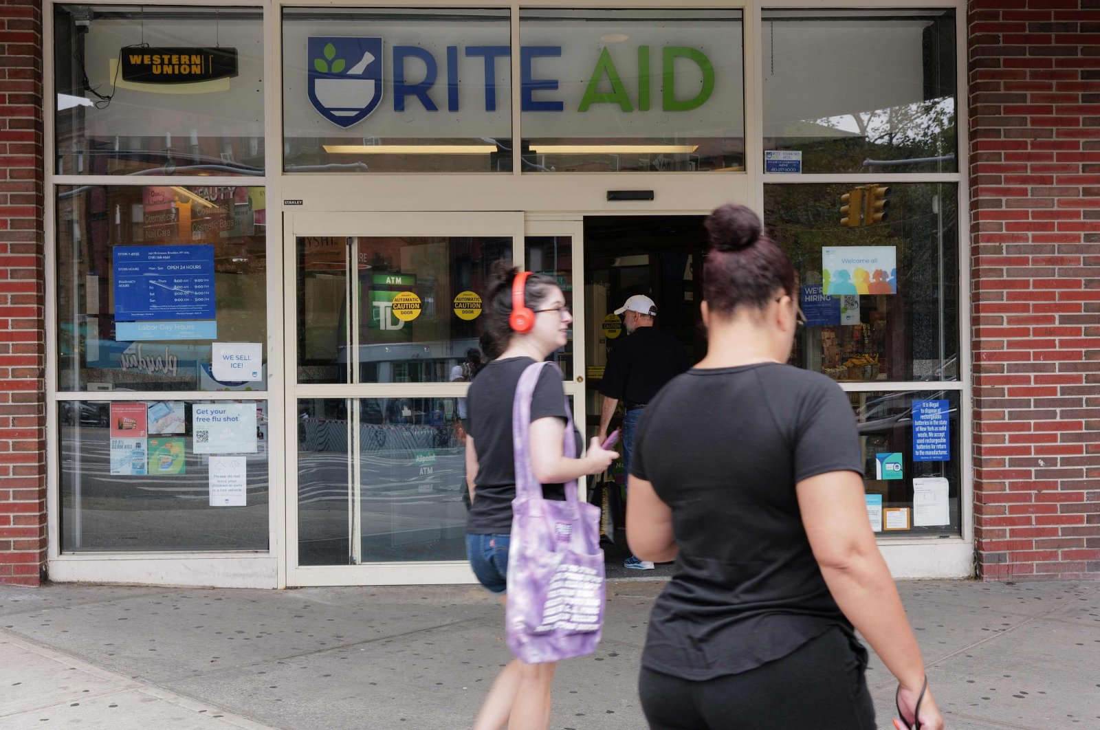 People walk past a Rite Aid store in Brooklyn, New York, U.S., Aug. 28, 2023. (AFP Photo)