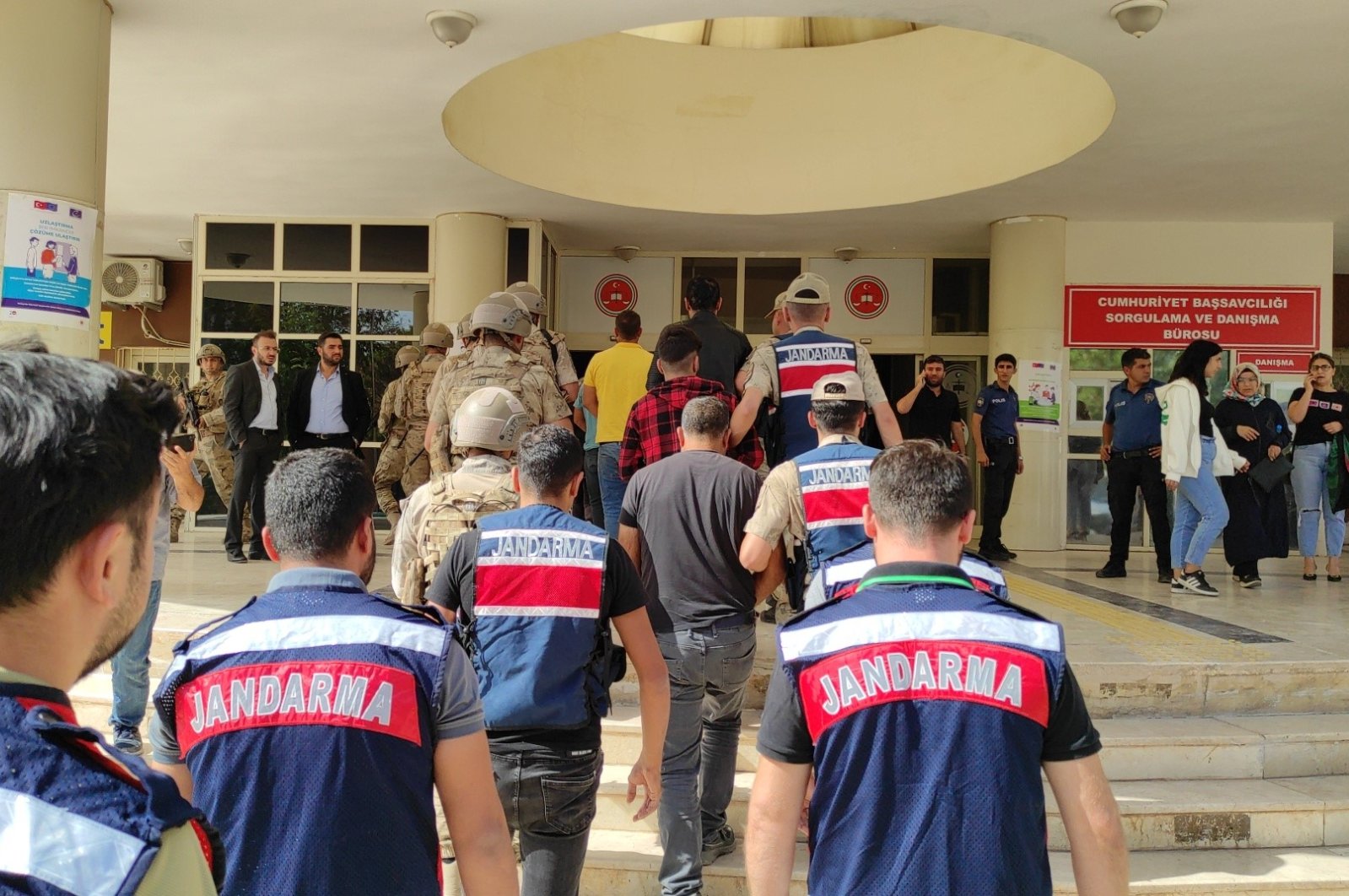 Turkish gendarmerie forces escort eight suspects detained in anti-PKK operations to the courthouse in the southeastern Şanlıurfa province, Türkiye, Oct. 12, 2023. (IHA Photo)