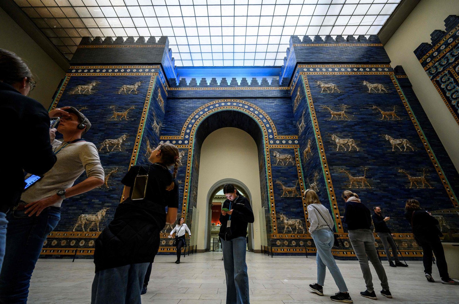 Visitors crowd the Ishtar Gate, constructed circa 575 B.C. by order of King Nebuchadnezzar II, in the south wing of The Pergamon Museum in Berlin, Germany, Oct. 5, 2023. (AFP Photo)  