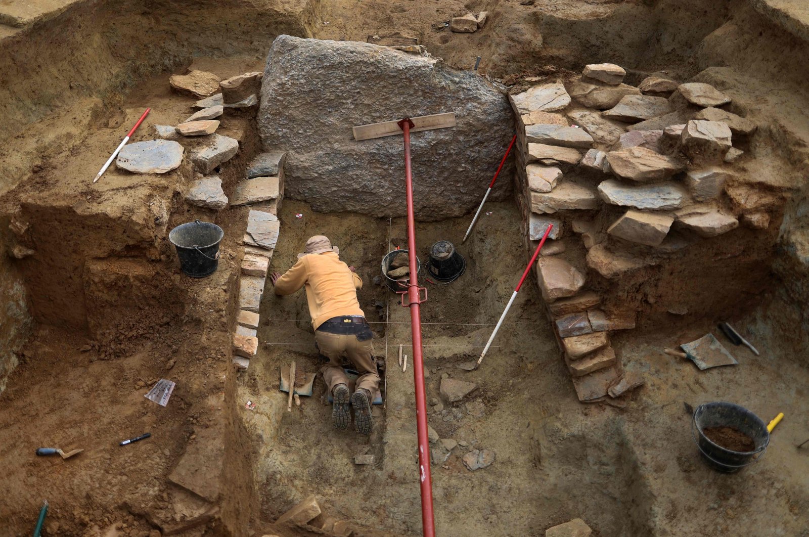 An archaeology student excavates a burial mound in Leuhan, western France, Oct. 11, 2023. (AFP Photo)