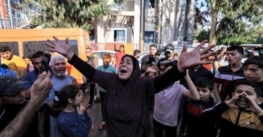 A woman reacts as people gather at the site of the Al-Ahli Baptist Hospital in the aftermath of an overnight strike, in central Gaza, Palestine, Oct. 18, 2023. (AFP Photo)
