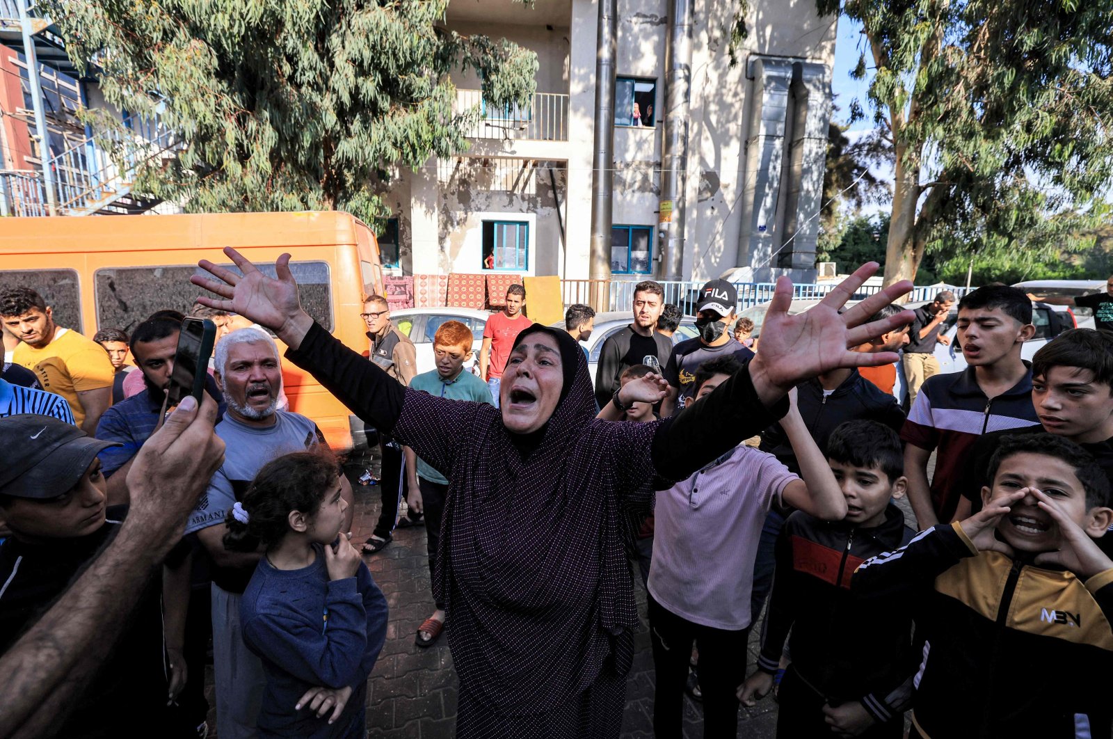 A woman reacts as people gather at the site of the Al-Ahli Baptist Hospital in the aftermath of an overnight strike, in central Gaza, Palestine, Oct. 18, 2023. (AFP Photo)