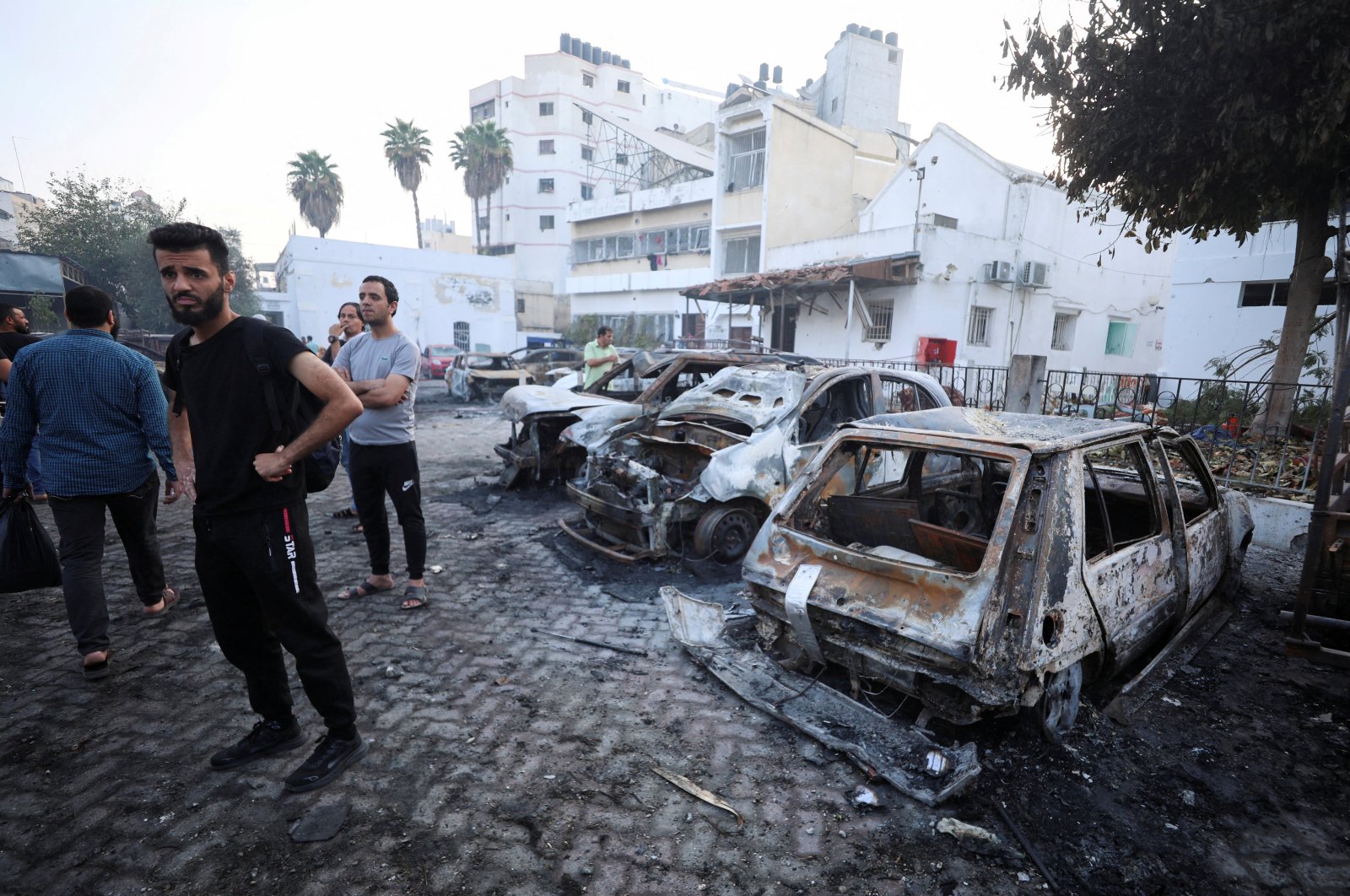 People inspect the area of the hospital where hundreds of Palestinians were killed in the Israeli attack, October 18, 2023. (Reuters Photo) 