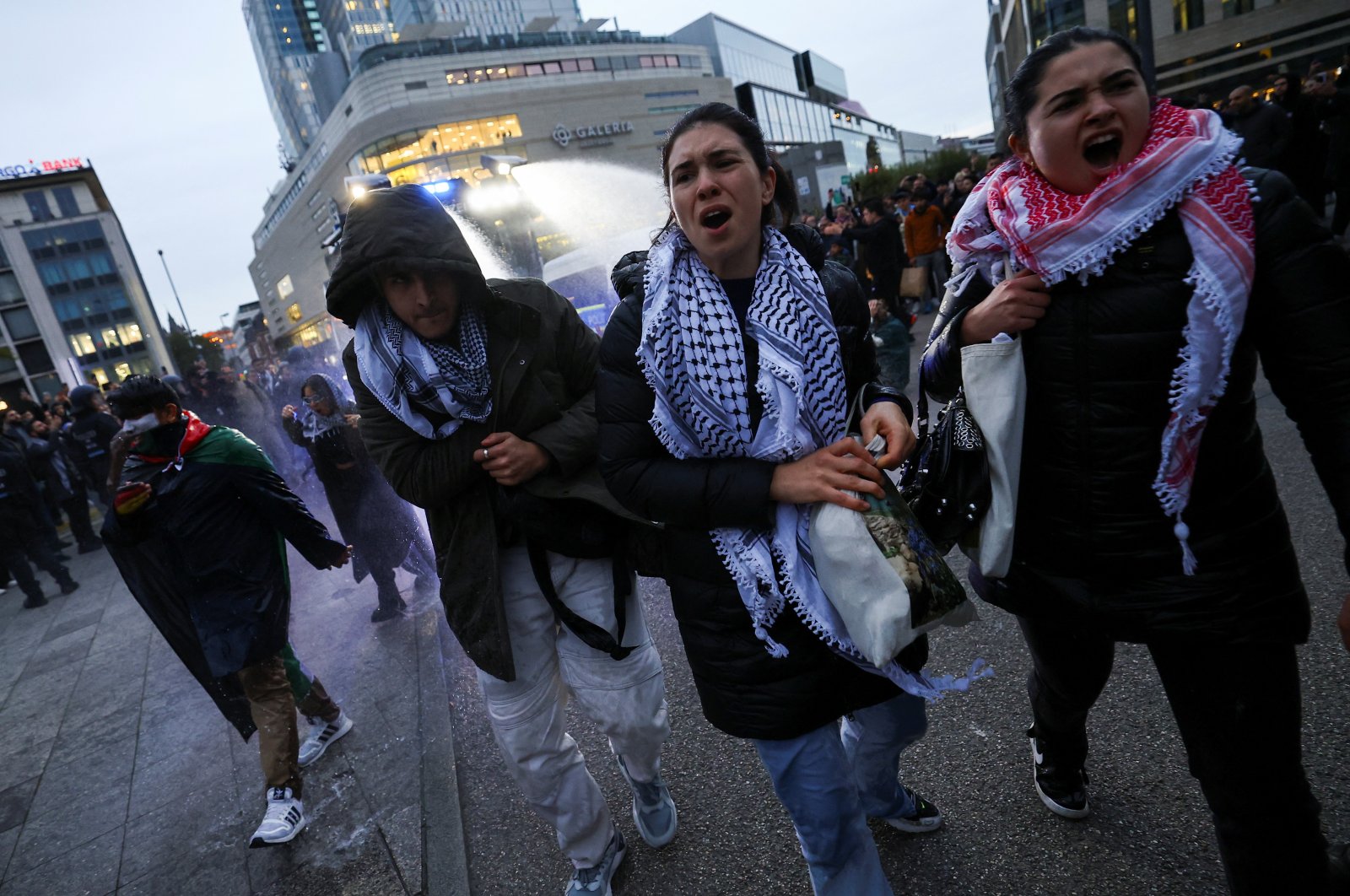 Pro-Palestinian demonstrators walk as police use water canons during a protest in Frankfurt, Germany, Oct. 18, 2023. (Reuters Photo)