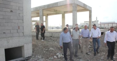 Akdeniz Mayor Mustafa Gültak (3rd R), alongside municipal technical staff and representatives from the contracting company, inspect the Akdeniz Youth Center construction site, Mersin, Türkiye, Oct. 19, 2023. (IHA Photo)