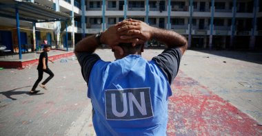 A U.N. volunteer stands in the yard of a U.N.-run school in the refugee camp of al-Maghazi in the central Gaza Strip, a day after at least six people were killed in a reported Israeli strike, Palestine, Oct. 18, 2023. (AFP Photo)