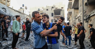 People react as Palestinian civil defense members and others search for survivors after an Israeli bombardment in Khan Yunis on the southern Gaza Strip, Palestine, Oct. 19, 2023. (AFP Photo)