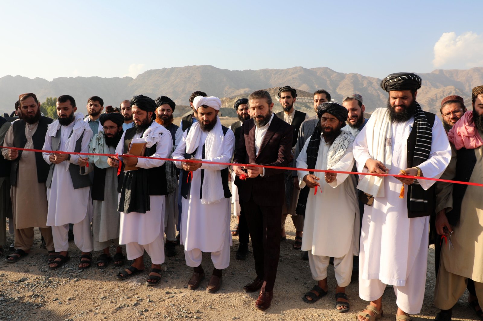 The ribbon-cutting ceremony is performed accompanied by prayers from officials of both Türkiye and Afghanistan, Mihtarlam, Afghanistan, Oct. 19, 2023. (AA Photo)