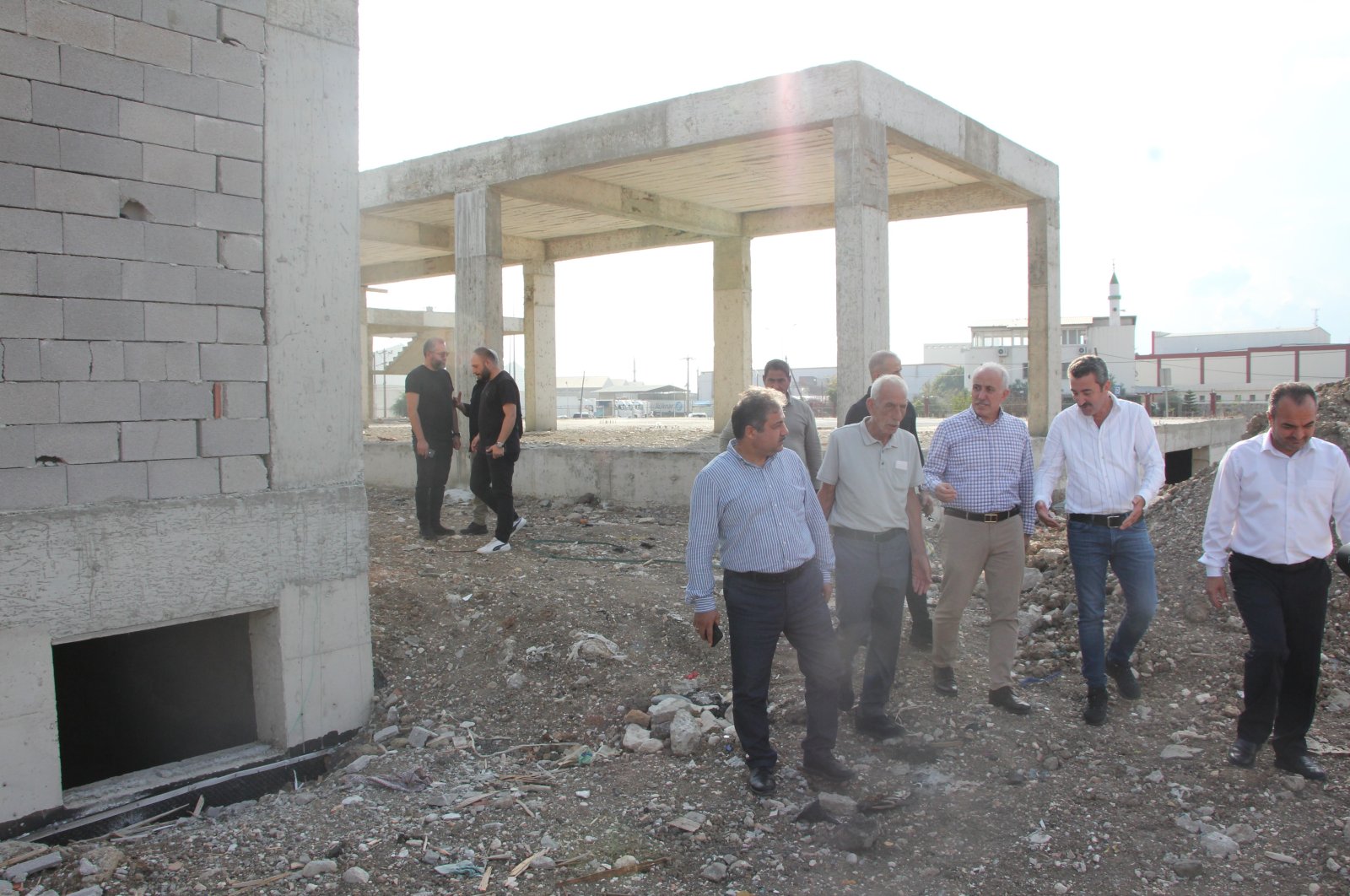 Akdeniz Mayor Mustafa Gültak (3rd R), alongside municipal technical staff and representatives from the contracting company, inspect the Akdeniz Youth Center construction site, Mersin, Türkiye, Oct. 19, 2023. (IHA Photo)