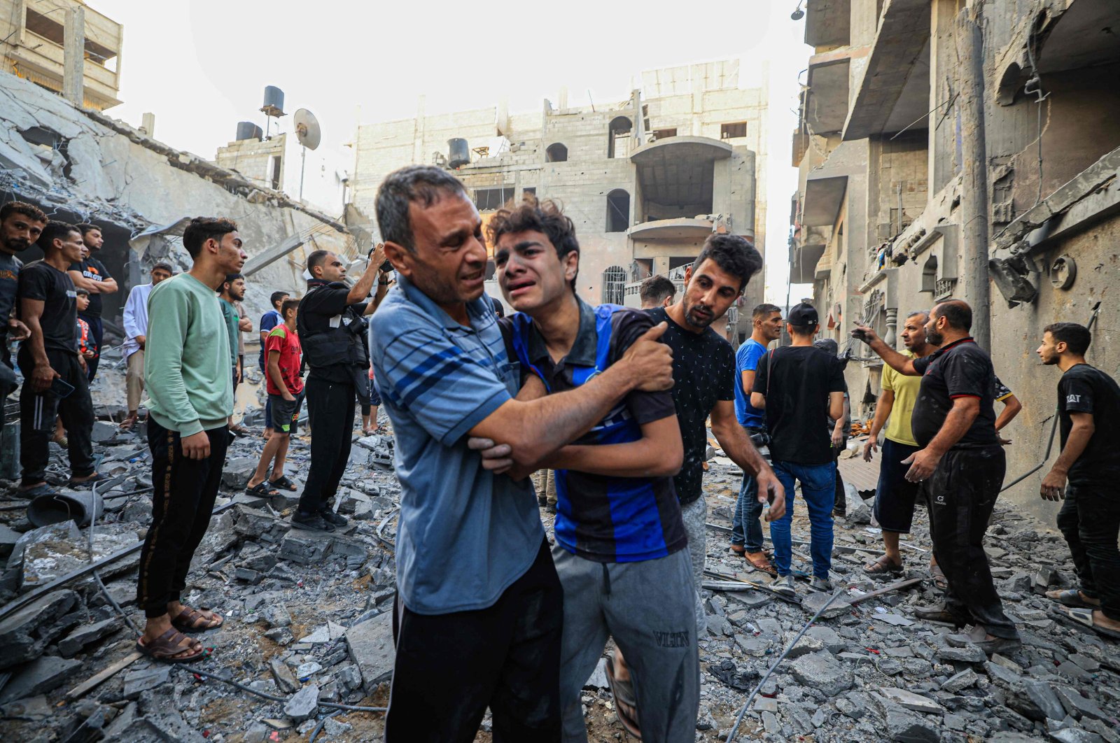 People react as Palestinian civil defense members and others search for survivors after an Israeli bombardment in Khan Yunis on the southern Gaza Strip, Palestine, Oct. 19, 2023. (AFP Photo)