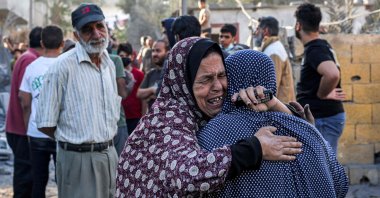 A woman consoles another as she reacts in the aftermath of Israeli bombardment in Rafah in the southern Gaza Strip, Palestine, Oct.19, 2023. (AFP Photo) 