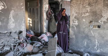 A woman reacts as she stands in a heavily damaged house following Israeli bombardment in Rafah in the southern of Gaza Strip, Palestine, Oct. 19, 2023. (AFP Photo)
