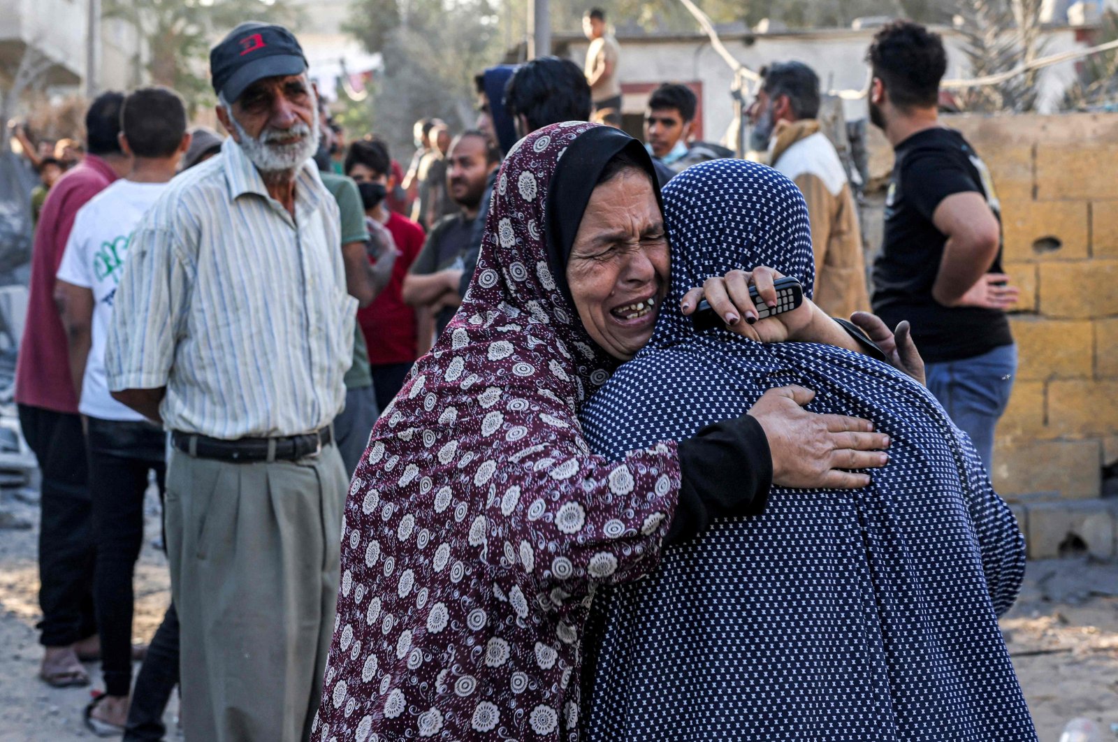 A woman consoles another as she reacts in the aftermath of Israeli bombardment in Rafah in the southern Gaza Strip, Palestine, Oct.19, 2023. (AFP Photo) 