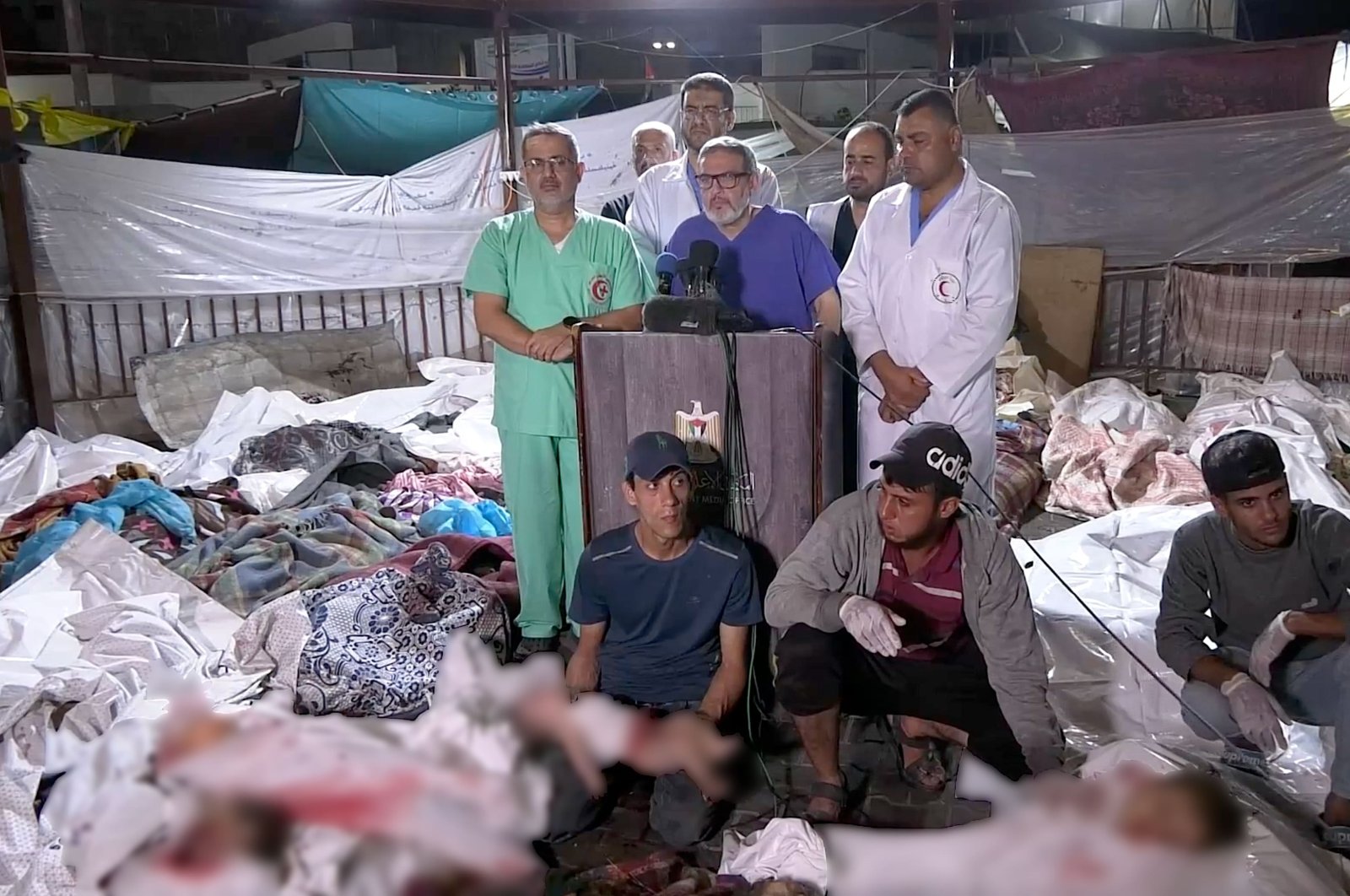 A screengrab captured from a video shows doctors issuing a statement to the press among lifeless bodies of the Israeli attack on Gaza&#039;s Al-Ahli Baptist Hospital, Gaza City, Palestine, Oct. 17, 2023. (Reuters Photo)