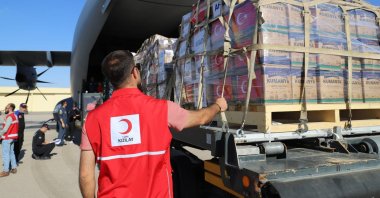 A Turkish Red Crescent worker is seen in front of an aircraft filled with humanitarian supplies sent from Türkiye to Gaza, Oct. 13, 2023. (AA File Photo)