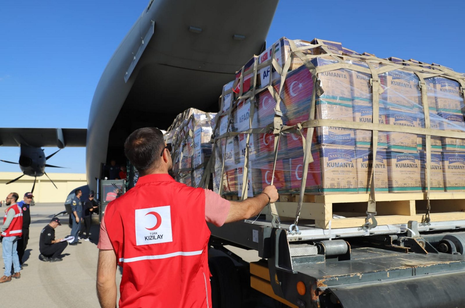 A Turkish Red Crescent worker is seen in front of an aircraft filled with humanitarian supplies sent from Türkiye to Gaza, Oct. 13, 2023. (AA File Photo)