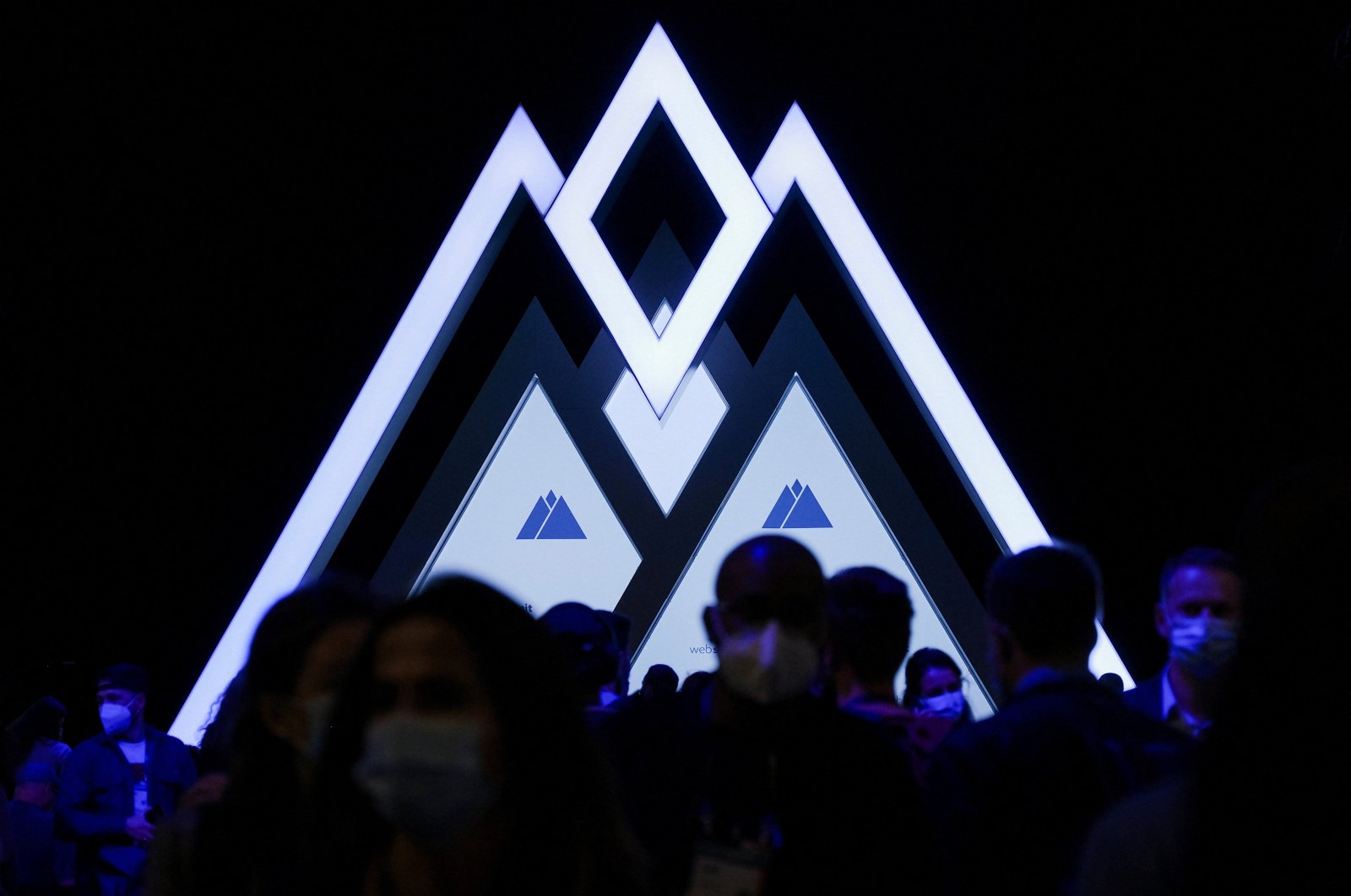 People pass by a Web Summit logo during Web Summit, Europe&#039;s largest technology conference, in Lisbon, Portugal, Nov. 3, 2021. (Reuters File Photo)