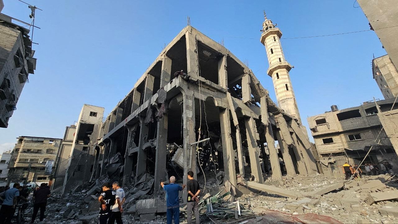 Palestinians gather around the remains of a mosque destroyed in Israeli strikes, northern Gaza Strip, Palestine, Oct. 22, 2023. (Reuters Photo)