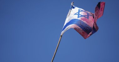 A demonstrator waves a colored Israeli flag during a protest against plans by Prime Minister Benjamin Netanyahu&#039;s government to overhaul the judicial system, outside the Knesset, Israel&#039;s parliament, in Jerusalem, July 24, 2023. (AP Photo)