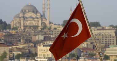 The Turkish flag is backdropped by the city's famous Süleymaniye Mosque, Istanbul, Türkiye. (Getty Images Photo)