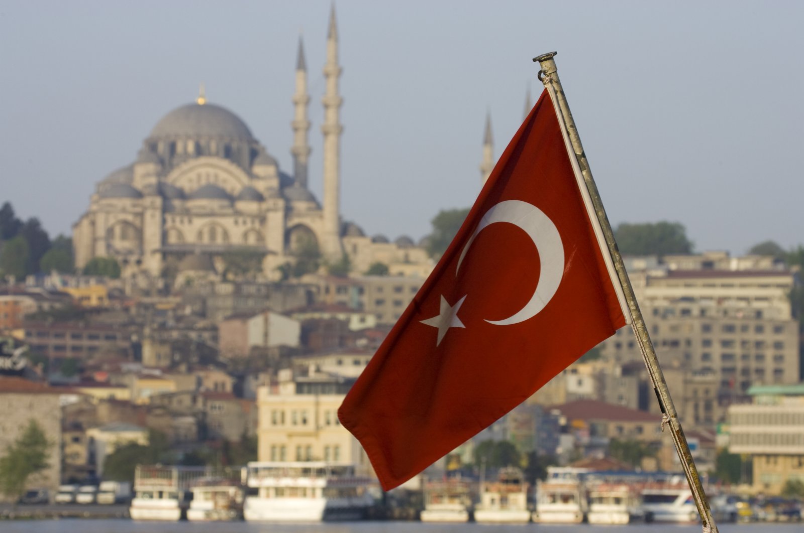 The Turkish flag is backdropped by the city&#039;s famous Süleymaniye Mosque, Istanbul, Türkiye. (Getty Images Photo)