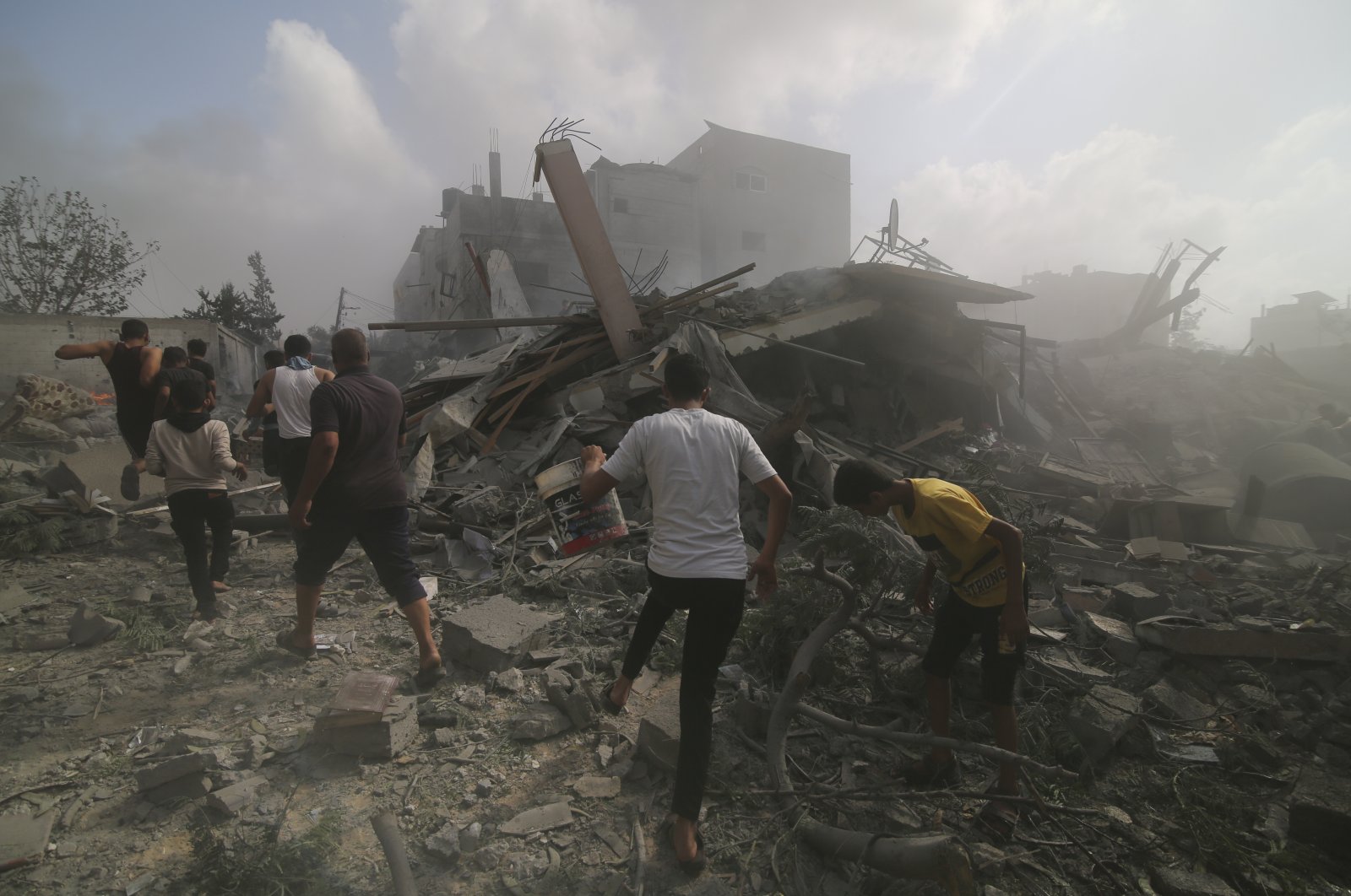 Palestinians look for survivors in buildings destroyed in the Israeli bombardment in Rafah, Gaza Strip, Palestine, Oct. 22, 2023. (AP Photo)