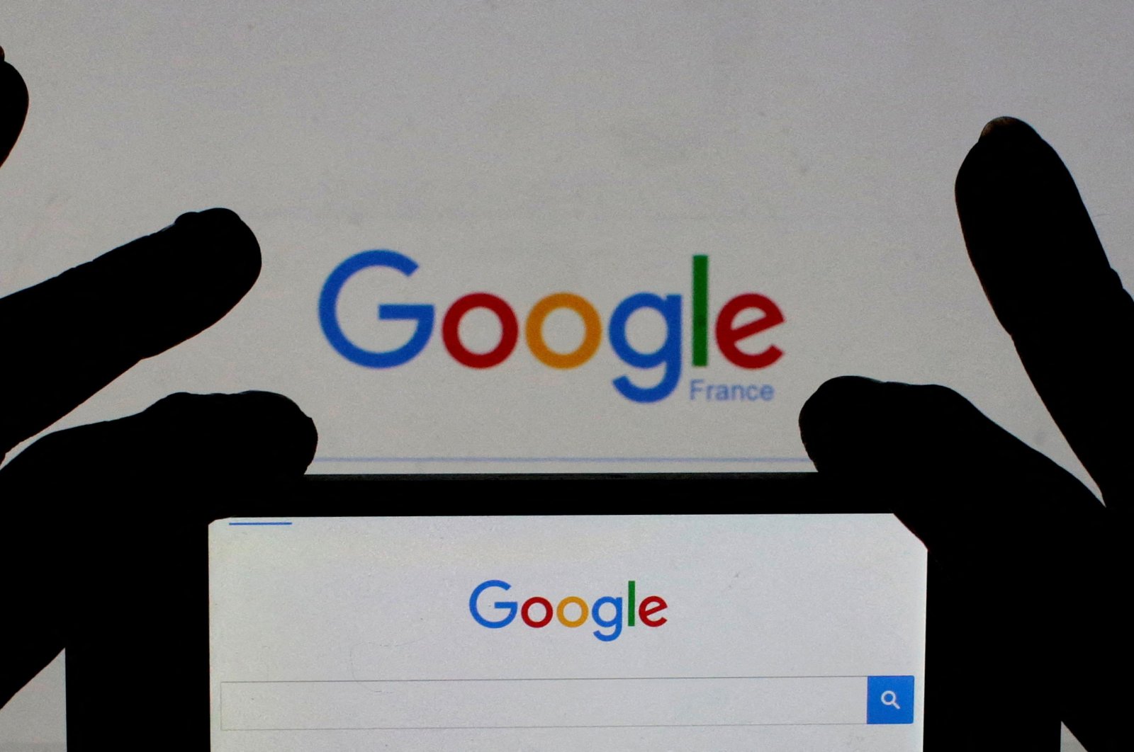 A woman holds her smartphone displaying Google&#039;s home page, in this picture illustration taken on Feb. 24, 2016. (Reuters Photo)