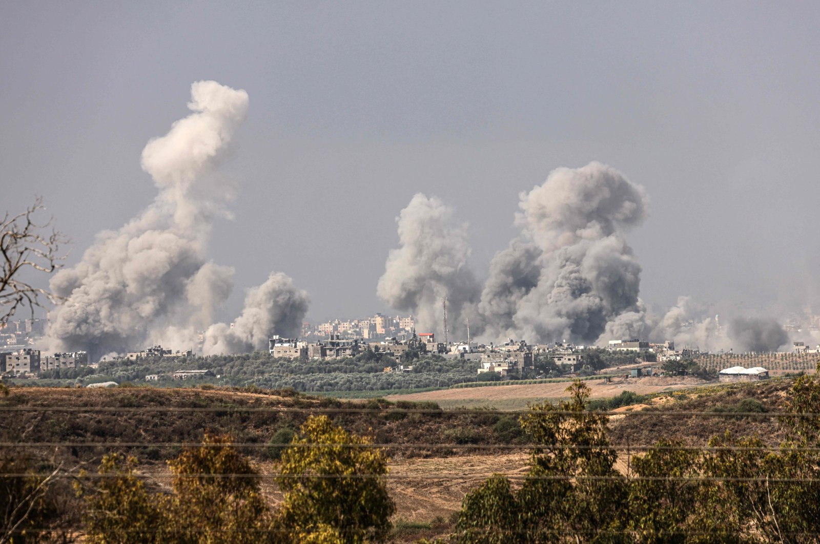 A picture taken from the southern Israeli city of Sderot shows smoke and debris ascending over the northern Gaza Strip following an Israeli strike, Oct. 23, 2023. (AFP Photo)