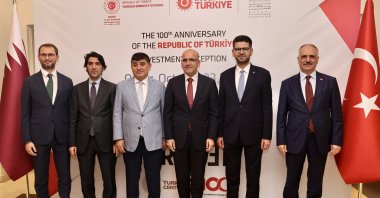 Turkish Ambassador in Doha Mehmet Mustafa Göksu (3rd L), Treasury and Finance Minister Mehmet Şimşek (3rd R) and head of the Investment Office of the Presidency of the Republic of Türkiye Ahmet Burak Dağlıoğlu (2nd R) are photographed during the reception in Doha, Qatar, Oct. 23, 2023. (AA Photo)