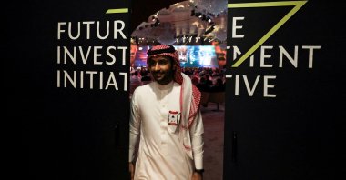 A Saudi man's reflection is seen in mirror glass at the Future Investment Initiative conference, Riyadh, Saudi Arabia, Oct. 25, 2022. (Reuters Photo)