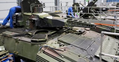 Employees work on Puma fighting vehicles at a production line of German company Rheinmetall, which produces weapons and ammunition for tanks and artillery, Unterluess, Germany, June 6, 2023. (Reuters Photo)