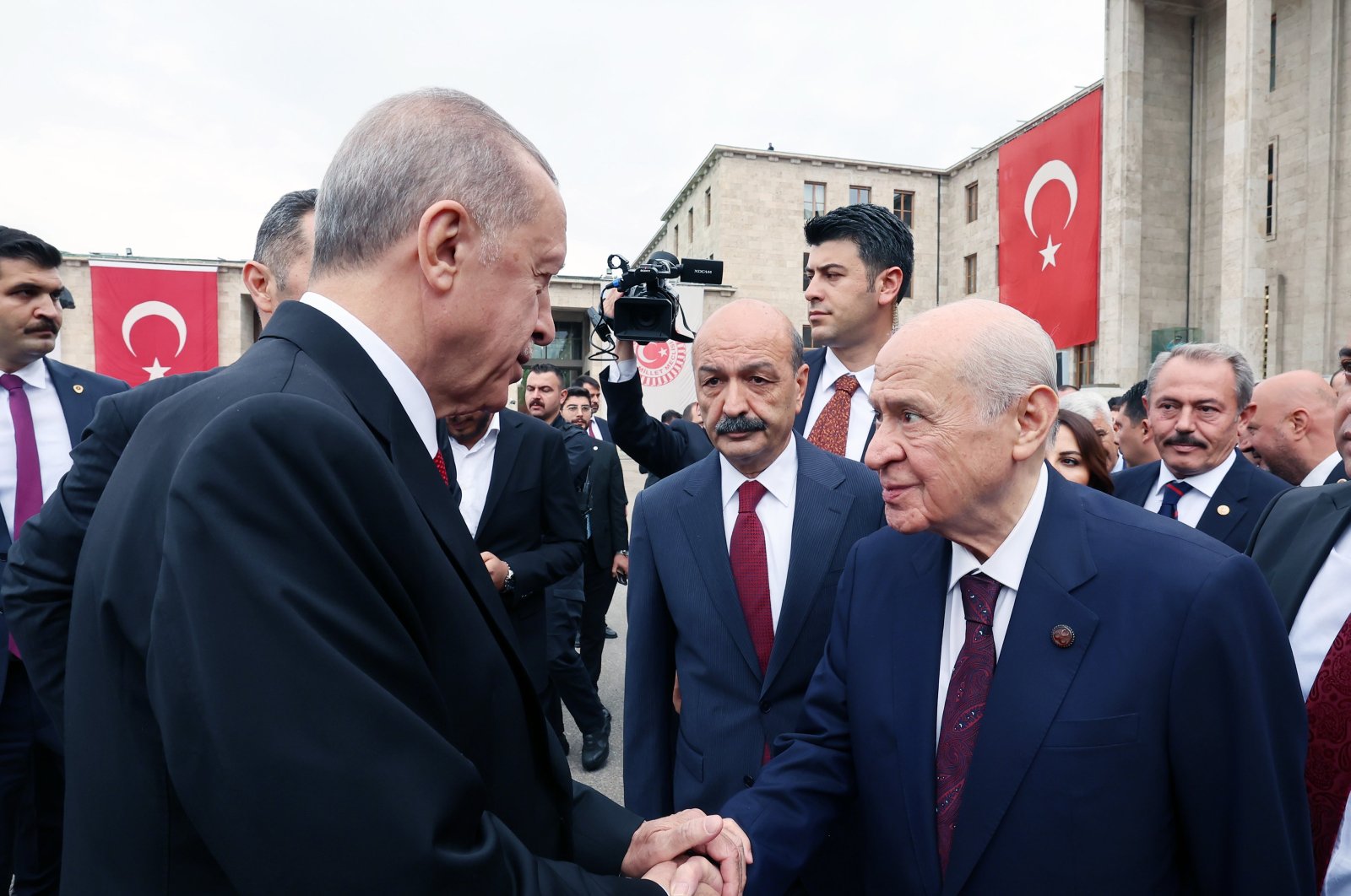 President Recep Tayyip Erdoğan shakes hands with MHP leader Devlet Bahçeli outside Parliament, in the capital Ankara, Türkiye, Oct. 1, 2023. (AA Photo)