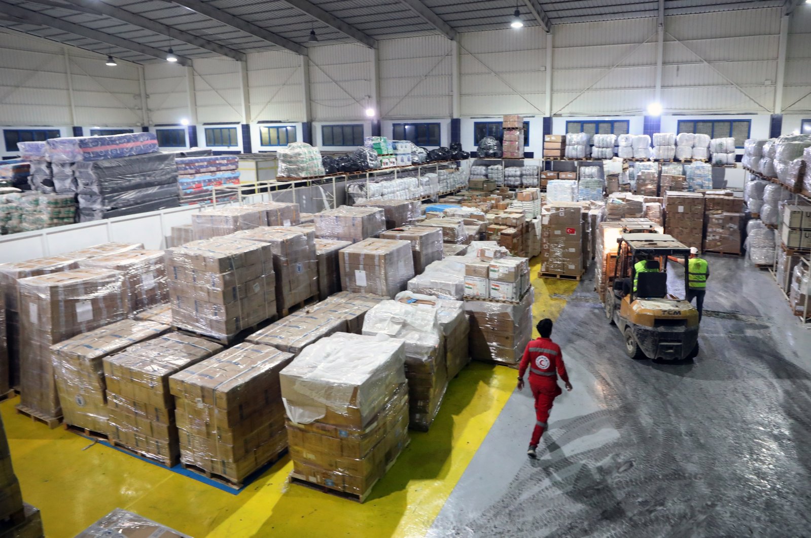 Egyptian Red Crescent Society employees handle humanitarian aid bound for Palestinians of the Gaza Strip, at a warehouse in Arish, Egypt, Oct. 23, 2023. (EPA Photo)