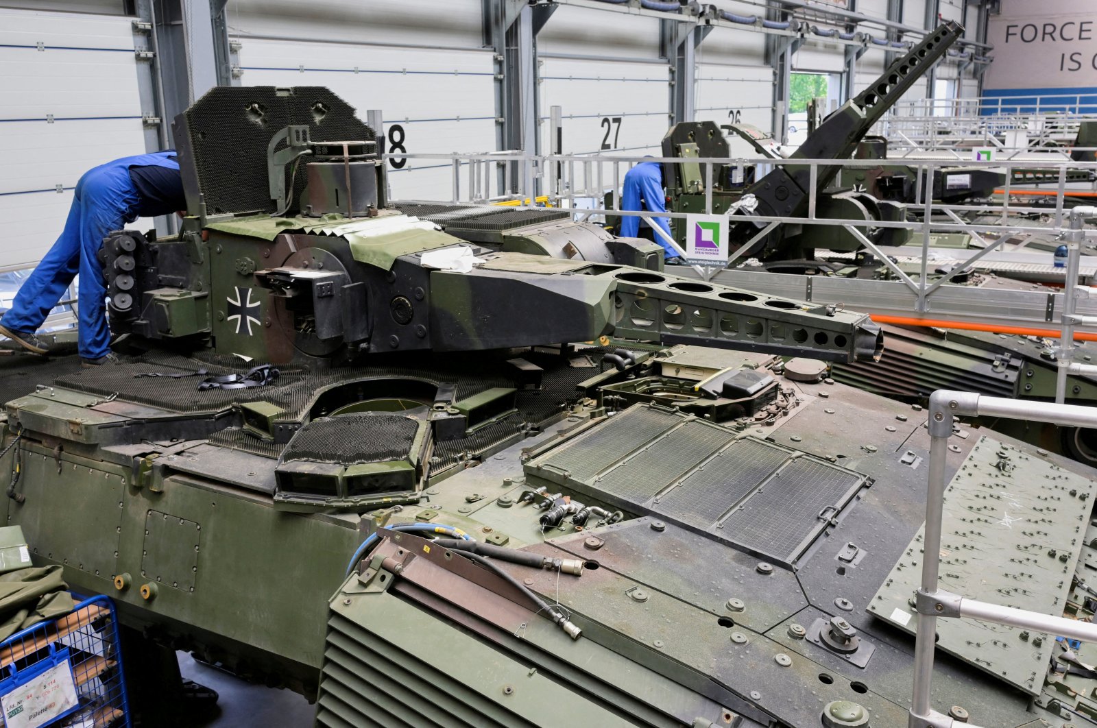 Employees work on Puma fighting vehicles at a production line of German company Rheinmetall, which produces weapons and ammunition for tanks and artillery, Unterluess, Germany, June 6, 2023. (Reuters Photo)