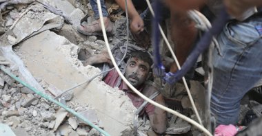 Palestinians rescue a survivor of Israeli bombardment of the Gaza Strip in Nusseirat refugee camp, Tuesday, Oct. 24, 2023. (AP Photo/Ali Mohmoud)
