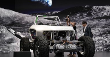 Media members gather around Japanese carmaker Toyota Motor's space mobility prototype at the Japan Mobility Show 2023 in Tokyo, Japan, Oct. 25, 2023. (EPA Photo)