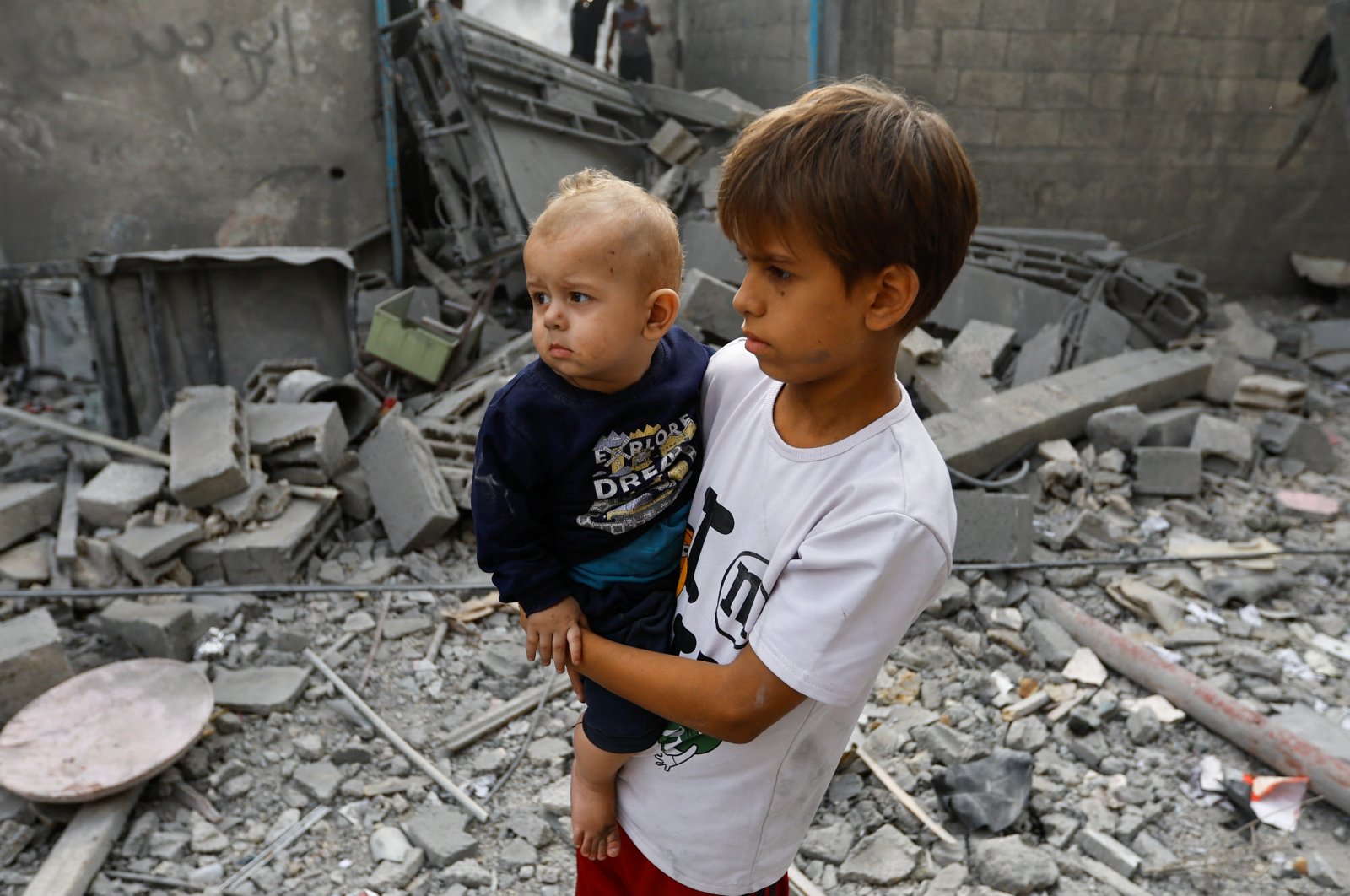Palestinian children standing amid rubble look on during a search for casualties in the aftermath of Israeli strikes on houses, in Khan Younis, southern Gaza Strip, Oct. 25, 2023. (Reuters Photo)