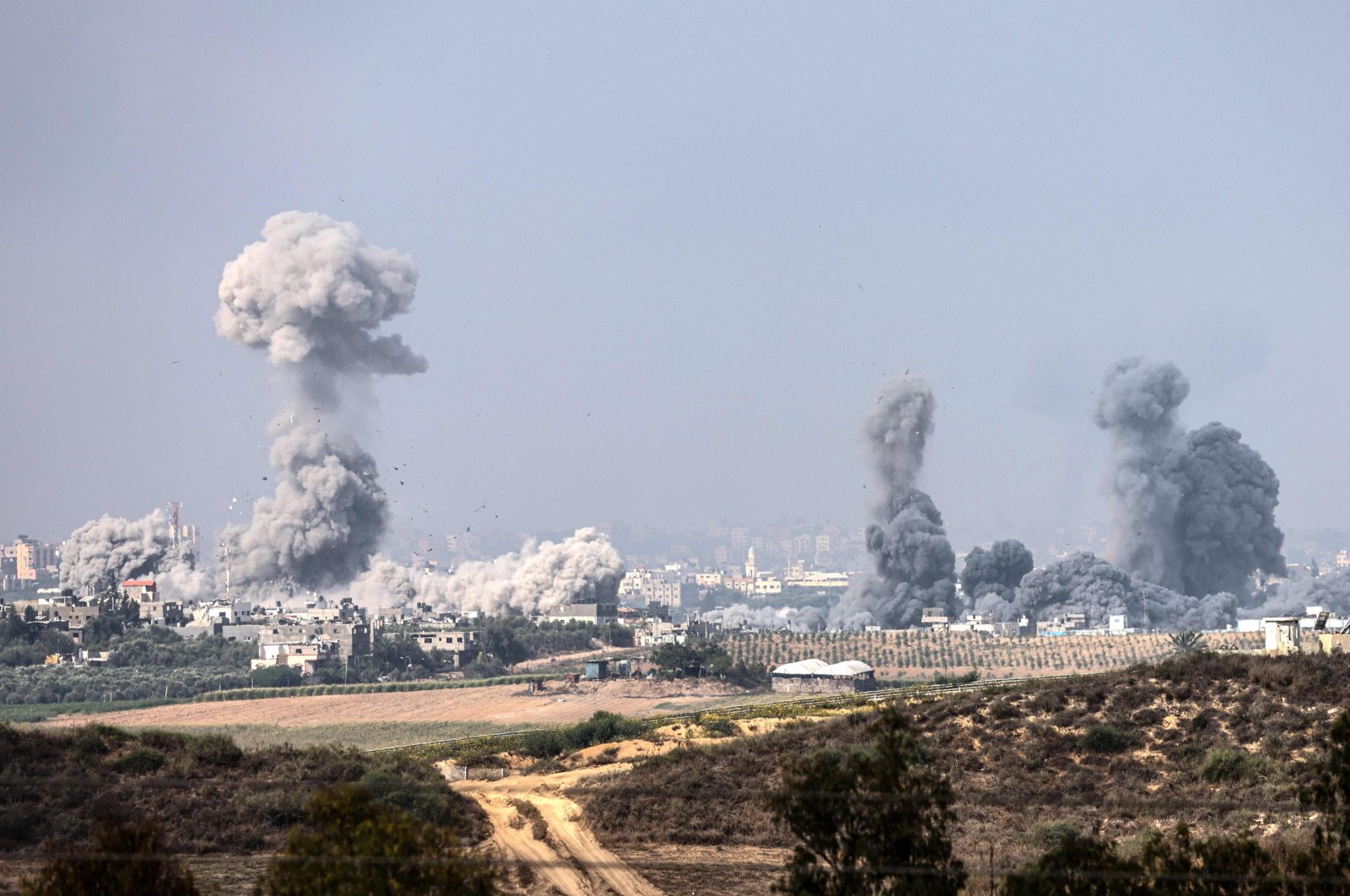 This picture taken from the southern Israeli city of Sderot shows smoke and debris ascending over the northern Gaza Strip following an Israeli strike, Oct. 23, 2023. (AFP Photo)