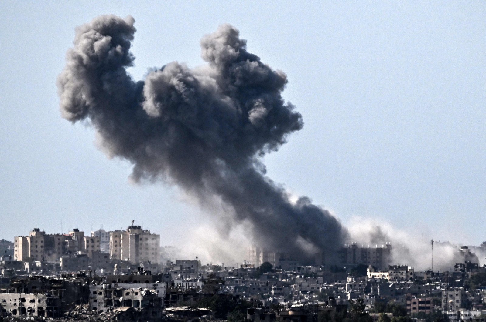 This picture taken from Sderot shows smoke rising over buildings in the Gaza Strip during an Israeli strike, Oct. 21, 2023. (AFP Photo)