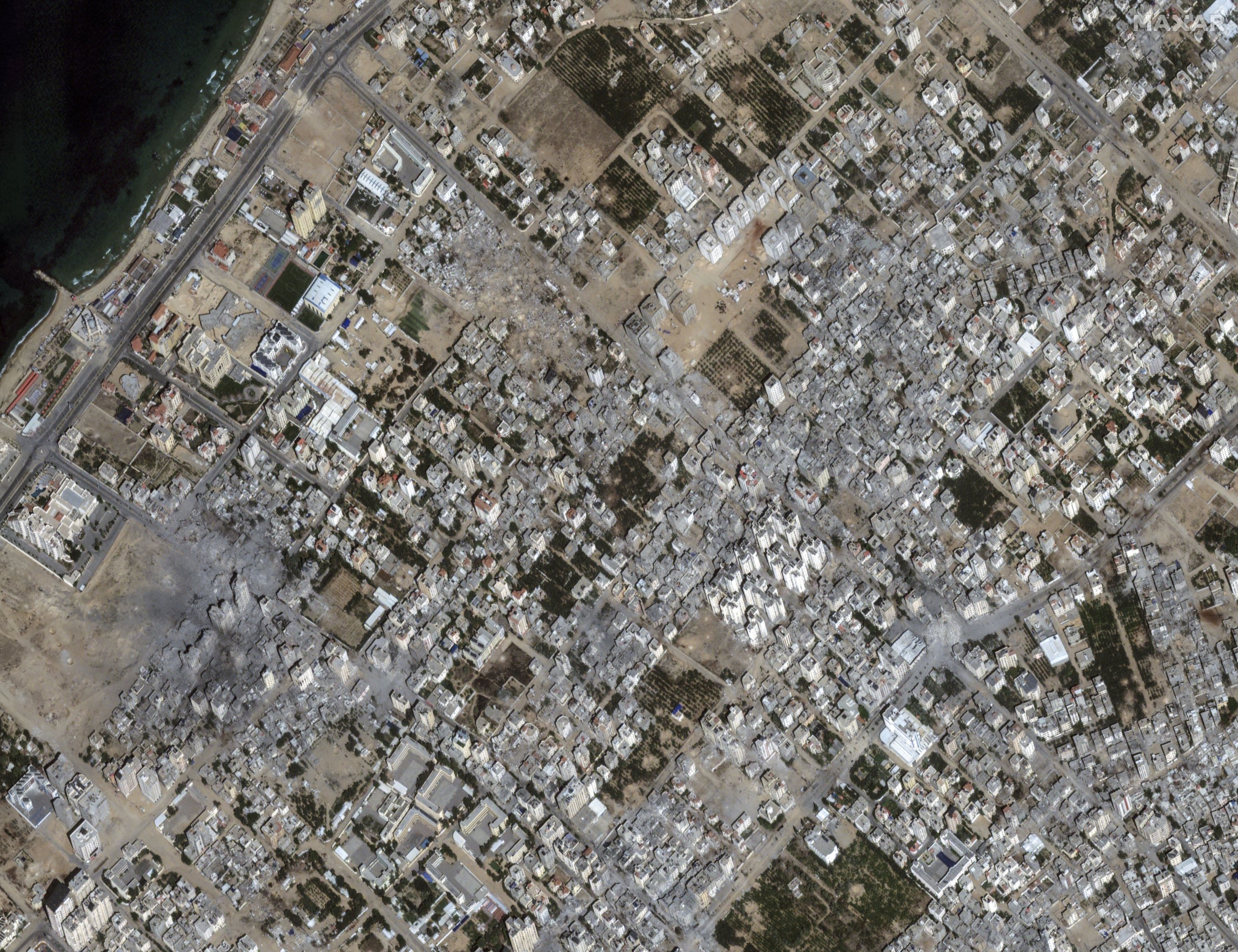 This image provided by Maxar Technologies shows damages to buildings and structures after bombing at Al Karameh neighborhood, in northern Gaza, Oct. 21, 2023. (Satellite image ©2023 Maxar Technologies via AP)