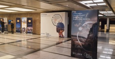 Organizers walk past posters reading “Conclude Your City With Conscience" ahead of the 18th GYODER Summit, Istanbul, Türkiye, Oct. 25, 2023. (Photo by Amina Ali)