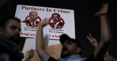 A banner depicting U.S. President Joe Biden and Israeli Prime Minister Benjamin Netanyahu is seen as Jordanians gather during a protest in support of Palestinians in Gaza, near the Israeli embassy, in Amman, Jordan, Oct. 24, 2023. (Reuters Photo)