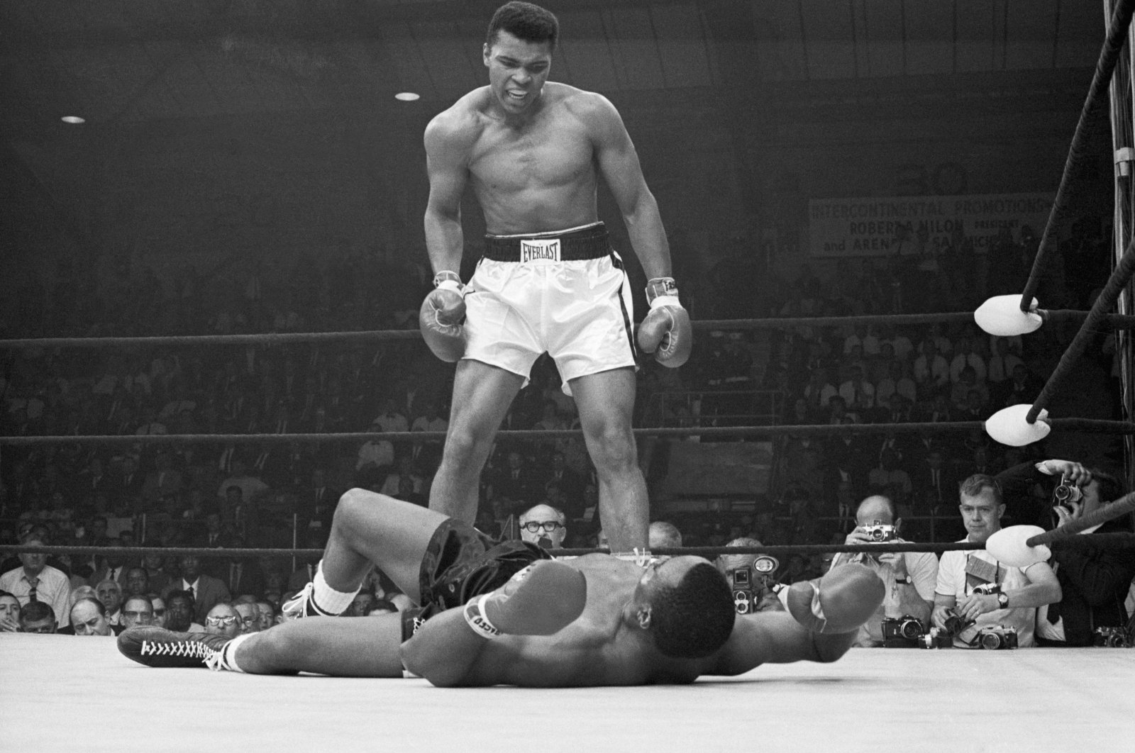 Heavyweight champion Muhammad Ali stands over Sonny Liston and taunts him to get up during their title fight. Ali knocked Liston out in one minute in the first round during their bout at the Central Maine Youth Center, Lewiston, Maine, May 25, 1965. (Getty Images Photo)