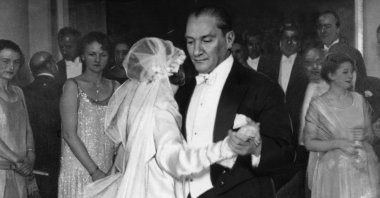 Guests clustered in a doorway watching as Mustafa Kemal Atatürk, the founder of the Turkish Republic, danced with his adopted daughter at her wedding, circa 1925. (Getty Images Photo)