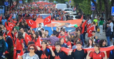 People walk with Turkish flags and a giant poster of Atatürk during the "Republic March" in Muğla, southwestern Türkiye, Oct. 23, 2023. (AA Photo)